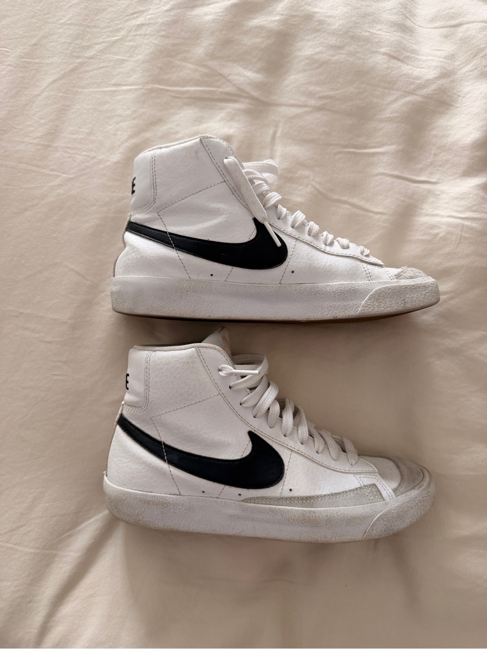 Nike Women's High-Top Sneakers in White with Black Swoosh and Orange Accent